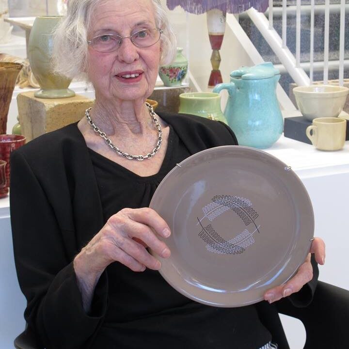 Joan Josling in November 2016, holding her husband Otway Josling's award winning design 'Reflections'. Designed in 1959, produced by Crown Lynn 