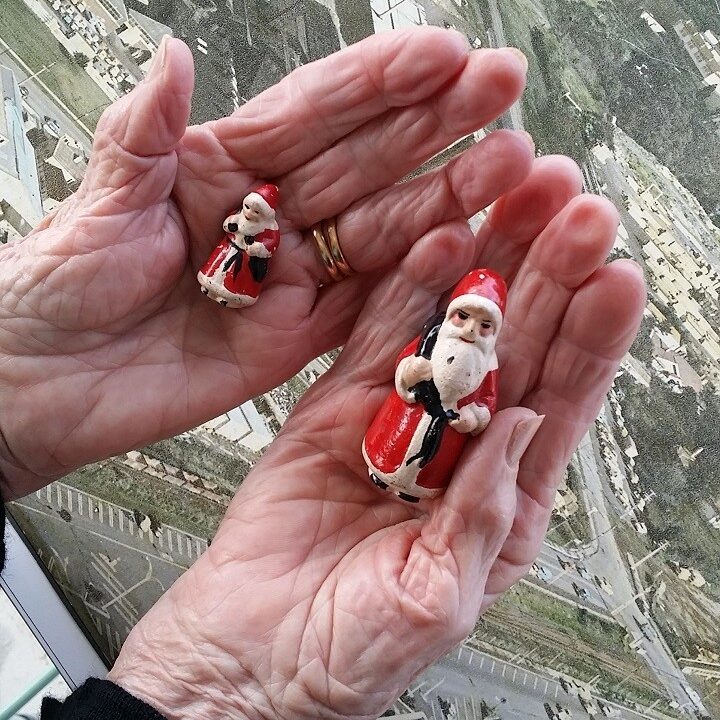 Annette Tuck in July 2017 holding two Spartan Santa's she decorated in the 1940s